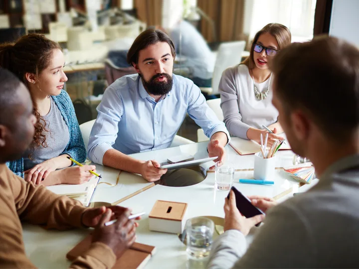 A leadership team meeting around a table during a strategy session