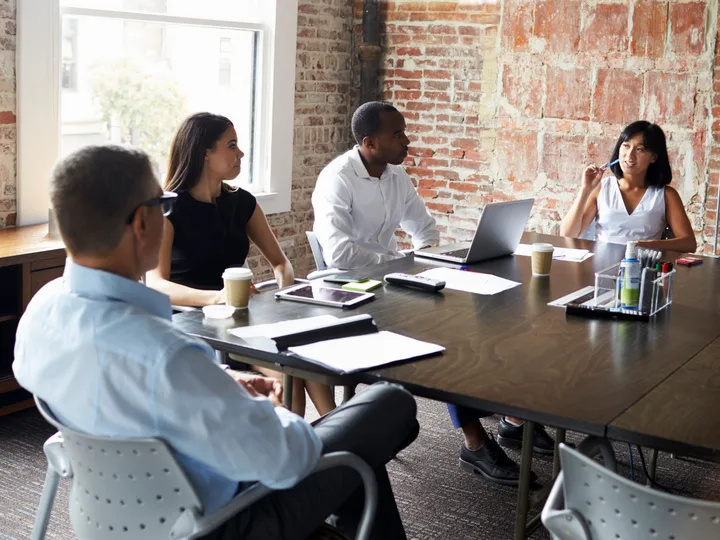 A small business team meeting around a conference table