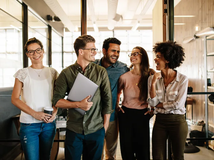 A small business team laughing together during a brand messaging session